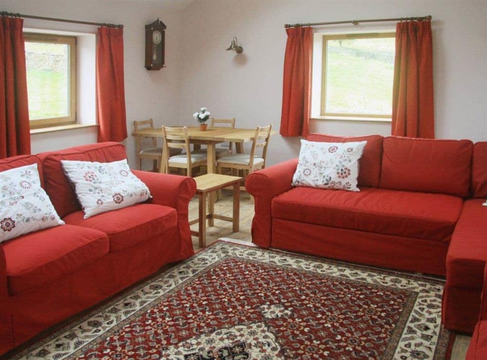Comfortable living room with modest dining area at Peggys Barn in Mallerstang, near Kirkby Stephen, Cumbria