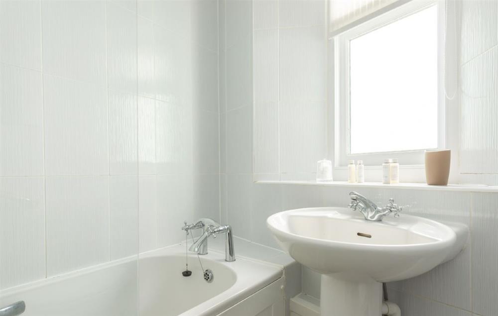 Bathroom with bath and shower over at Pelorus Cottage, Trevose Head Lighthouse
