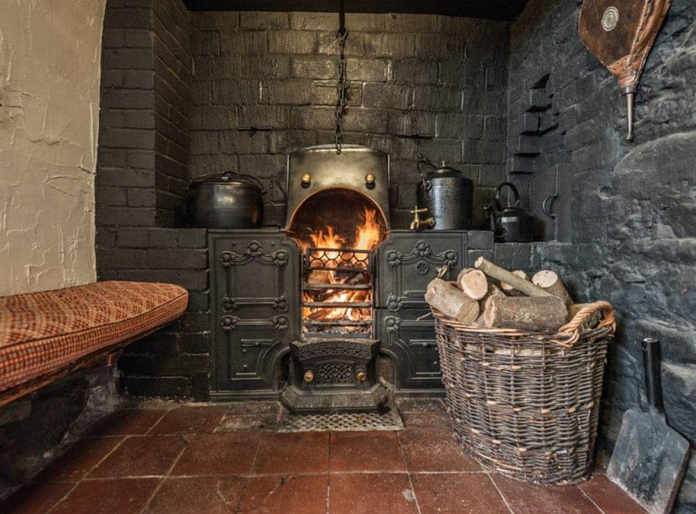 Living room with cobbled floor, open fire & many original features (photo 4) at Pen Copi in Trefeglwys, near Caersws, Powys