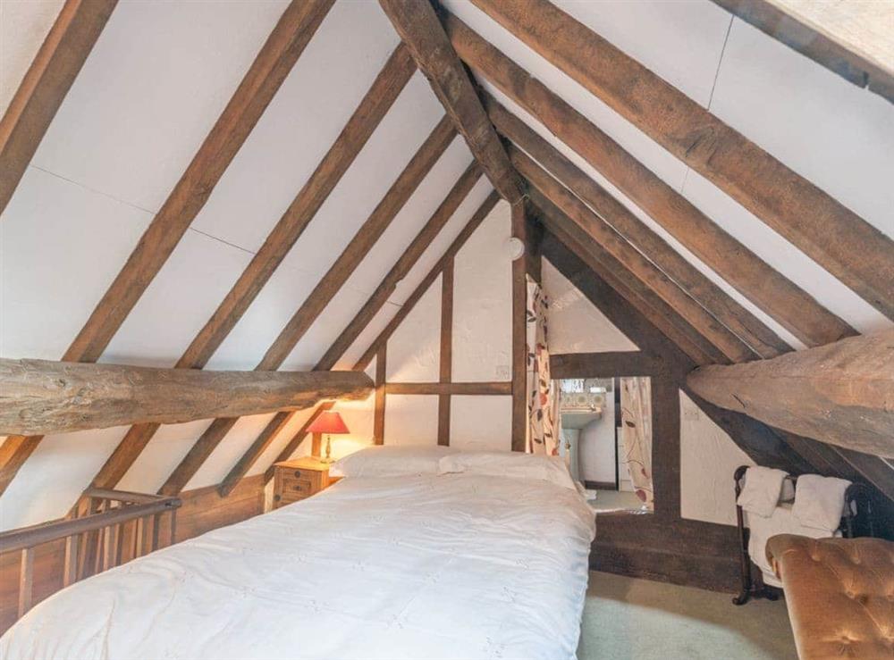 Single bedroom with traditional features including beamed ceiling at Pen Copi in Trefeglwys, near Caersws, Powys