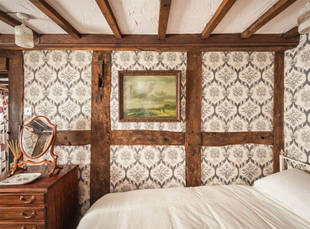 Twin bedroom with traditional features including beamed ceiling at Pen Copi in Trefeglwys, near Caersws, Powys