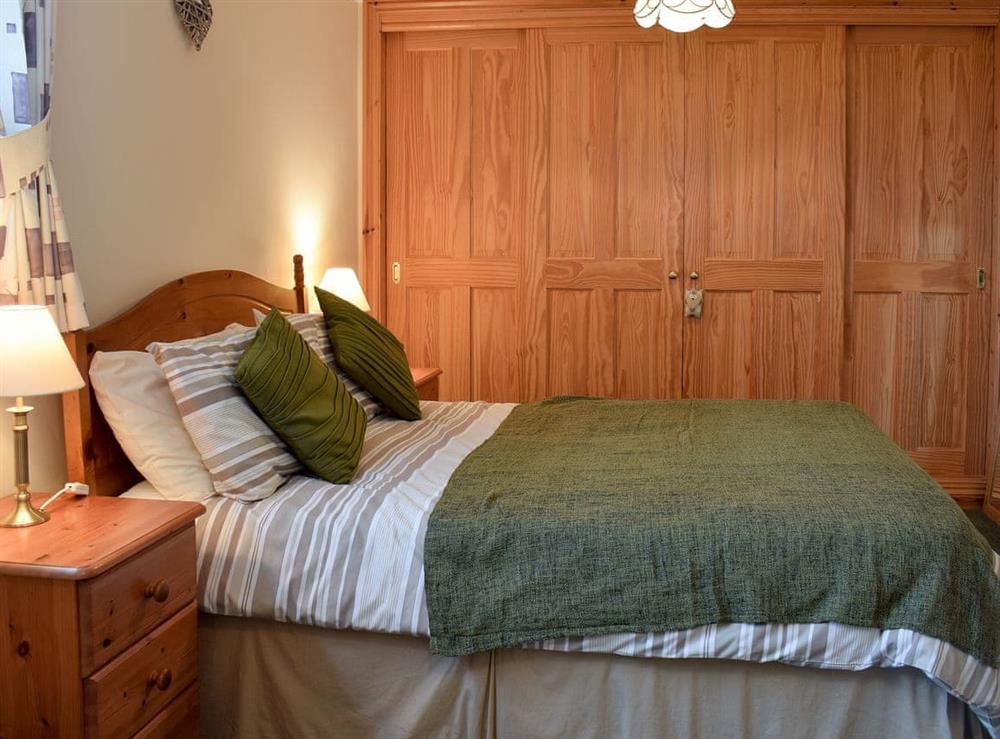 Bedroom with double & 2 single beds at Pen Y Bryn Apartment in Manordeilo, near Llandeilo, Dyfed
