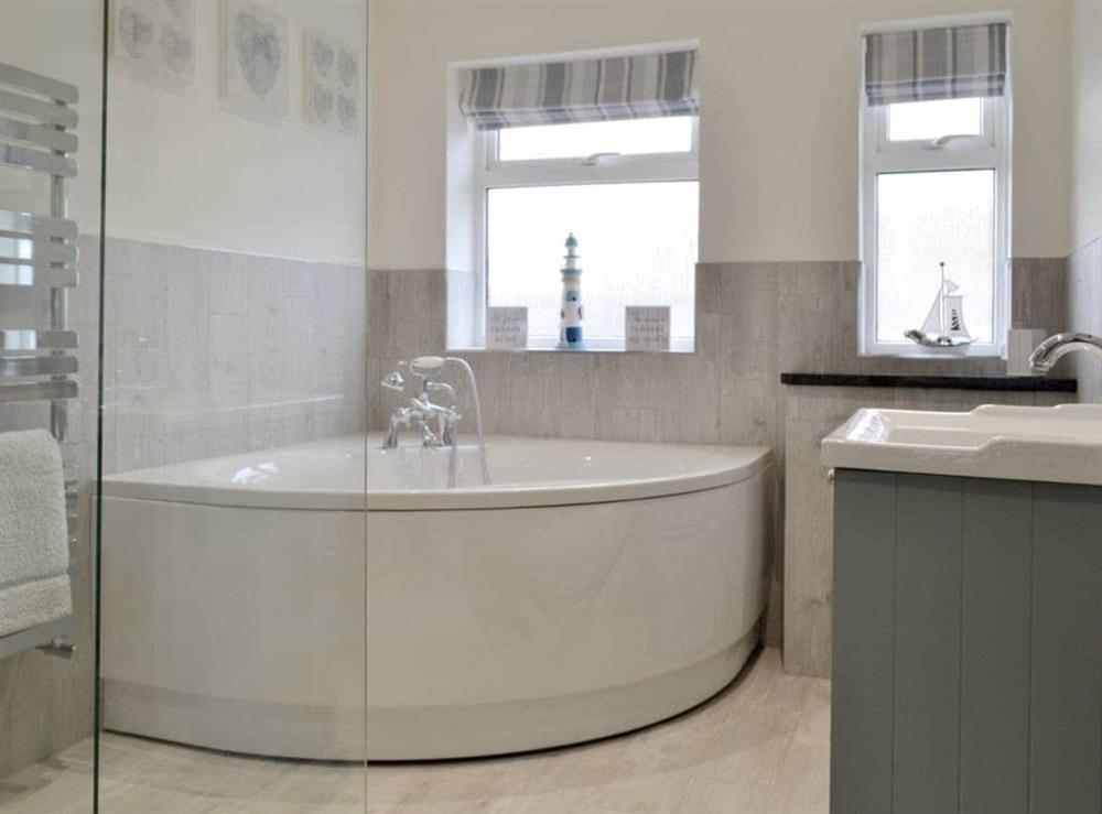 Family bathroom with corner bath and separate walk-in shower cubicle at Pen Y Frith in Prestatyn, Clwyd