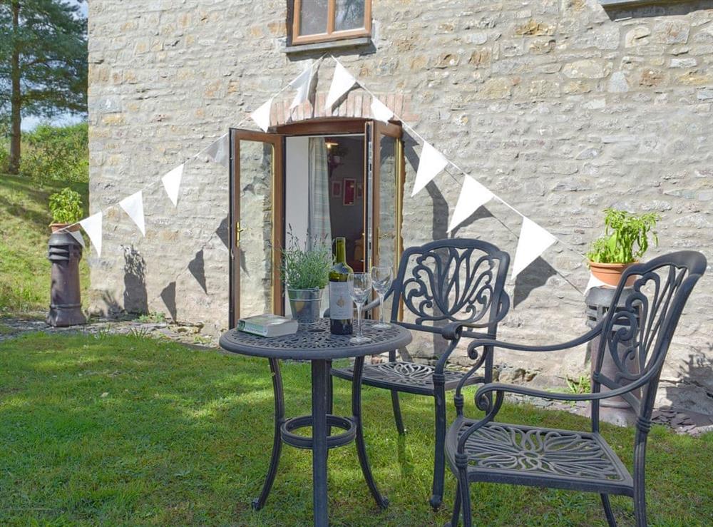 Lawned garden area with outdoor furniture at Mill Cottage, 