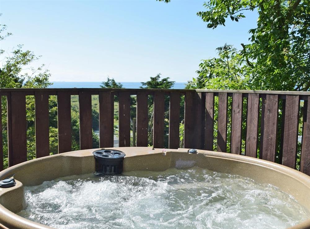 Inviting hot tub area at Pendine Manor in Pendine, near Laugharne, Dyfed