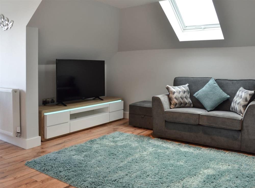 Lounge area with TV at Penfose Apartment in Mevagissey, Cornwall