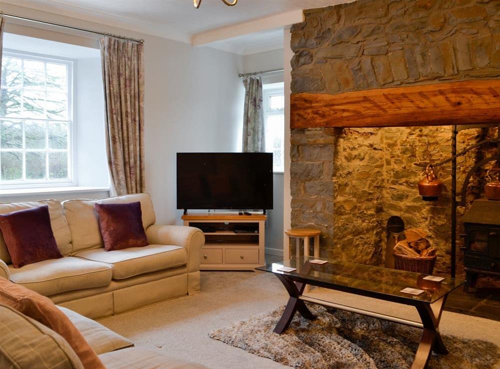 Living room with inglenook fireplace and wood burner at Pengarreg Fawr in Llanilar, near Aberystwyth, Dyfed