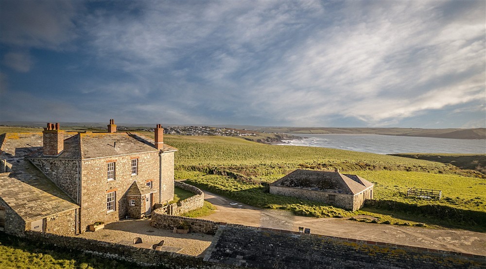 The exterior of Pengirt, joined to Pentire Head Farmhouse and the nearby coast, Cornwall at Pengirt in Polzeath, Cornwall