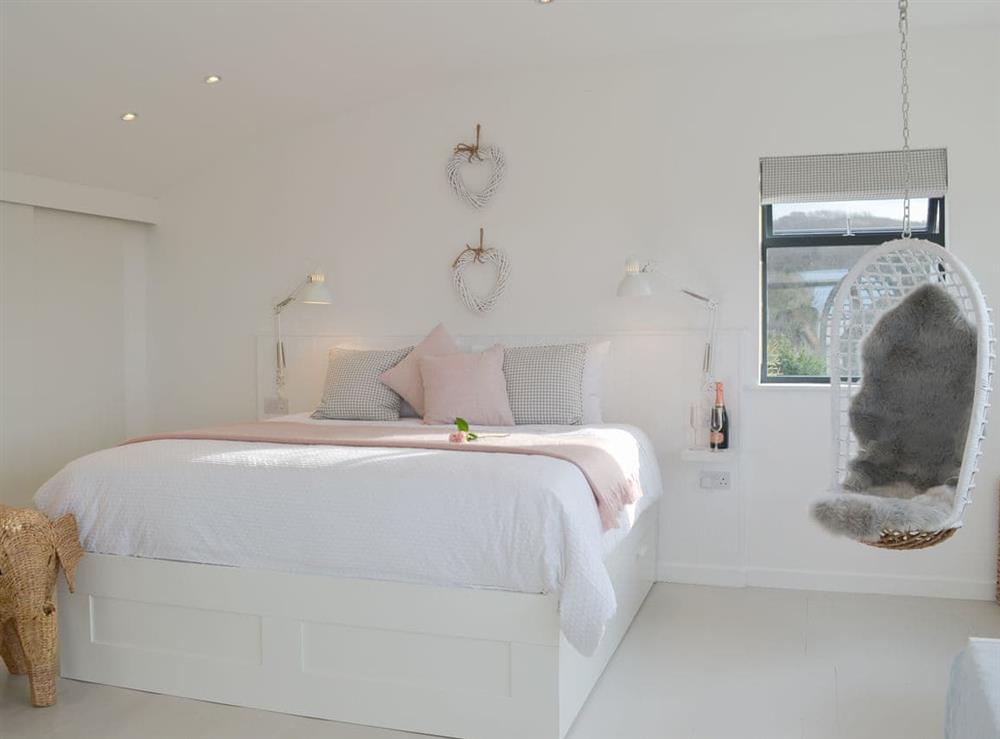 Luxurious master bedroom with sweeping curved ceiling at Pengwyn in Trethevy, near Tintagel, Cornwall