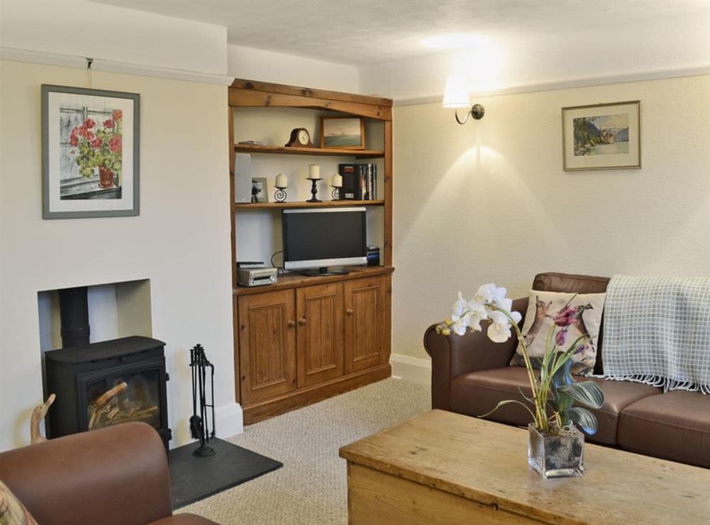 Tastefully furnished living room with wood burner at Penhill Farm Cottage in Fremington, near Barnstaple, Devon