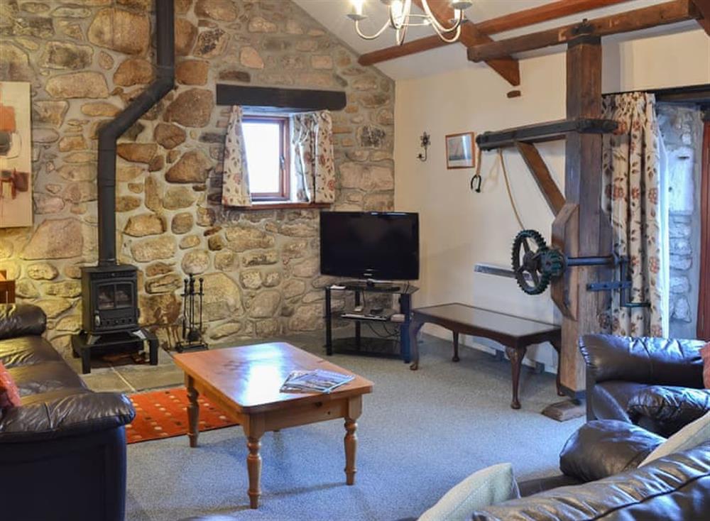 Cosy living room with wood burner at Penny Farthing in Trewellard, near Penzance, Cornwall
