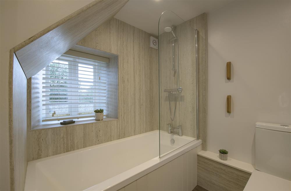 Bath with overhead shower attachment at Penny Pot Cottage, Middleham, North Yorkshire
