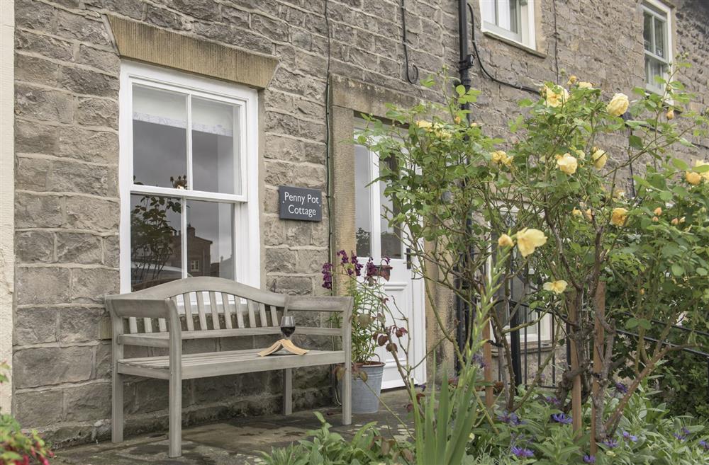 Main entrance and the perfect spot for morning coffee whilst watching the world go by at Penny Pot Cottage, Middleham, North Yorkshire