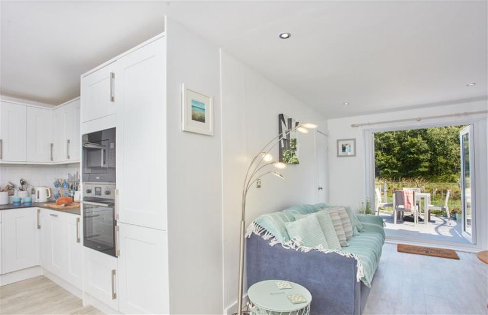 Penpoll, Cornwall: Open-plan living area with french doors leading to terrace at Penpoll, Little Petherick