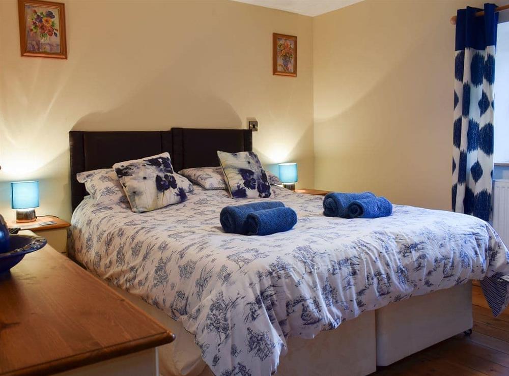 Relaxing bedroom with kingsize bed at Penrhiw, 
