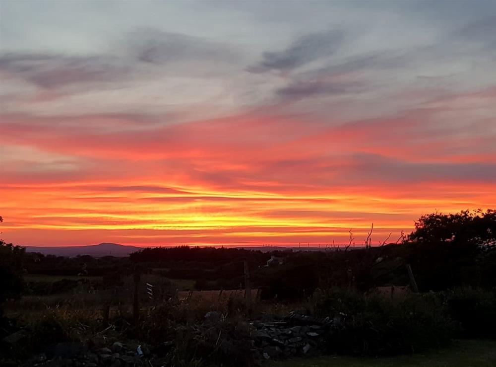 Dramatic sunsets can be experienced from the garden at Penrhos Bach in Carmel, near Llangefni, Anglesey, Gwynedd