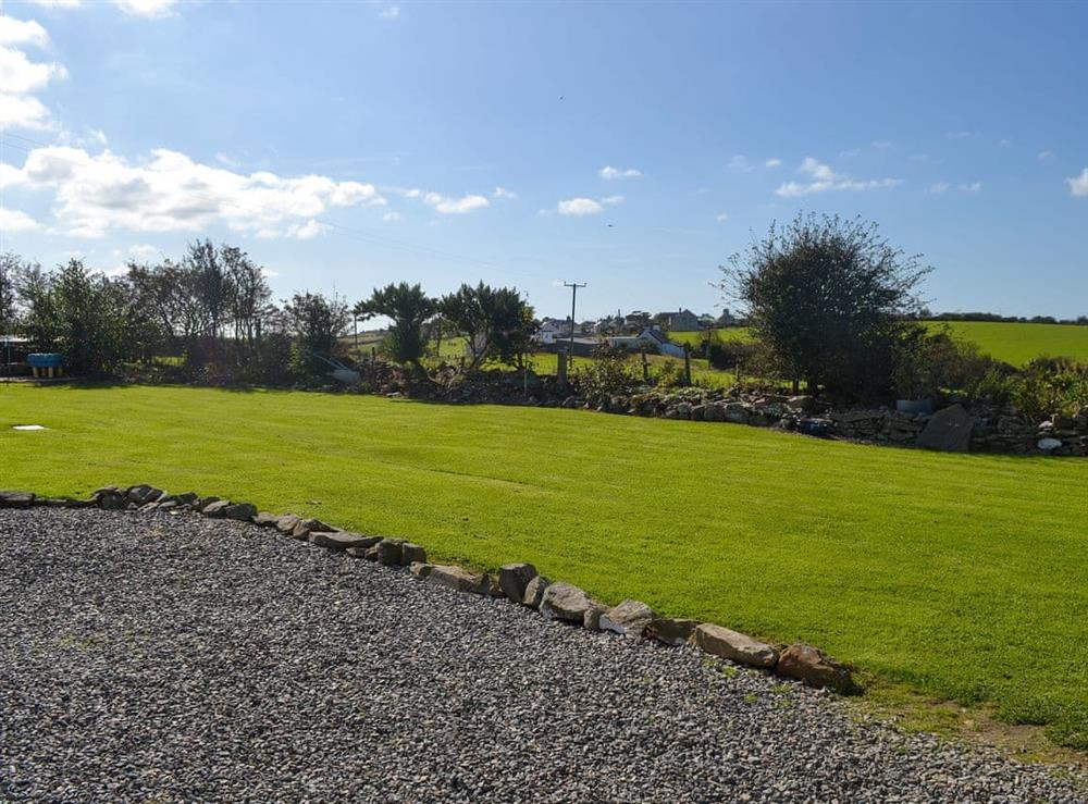 Shared, lawned garden at Penrhos Bach in Carmel, near Llangefni, Anglesey, Gwynedd