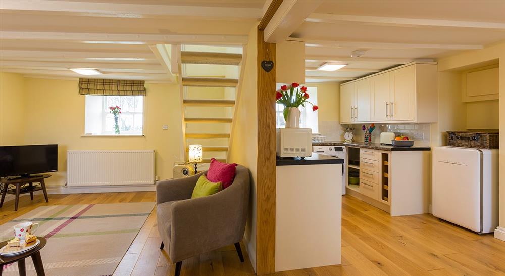 The sitting room and kitchen at Penrhyn Mawr in Cemaes Bay, Gwynedd