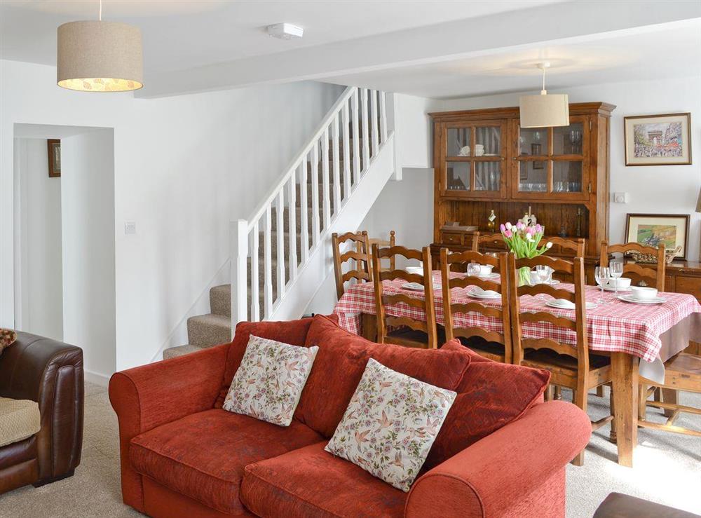 Dining area and stairs to upper level in living room at Penteryfn in near Holyhead, Isle of Anglesey, Gwynedd