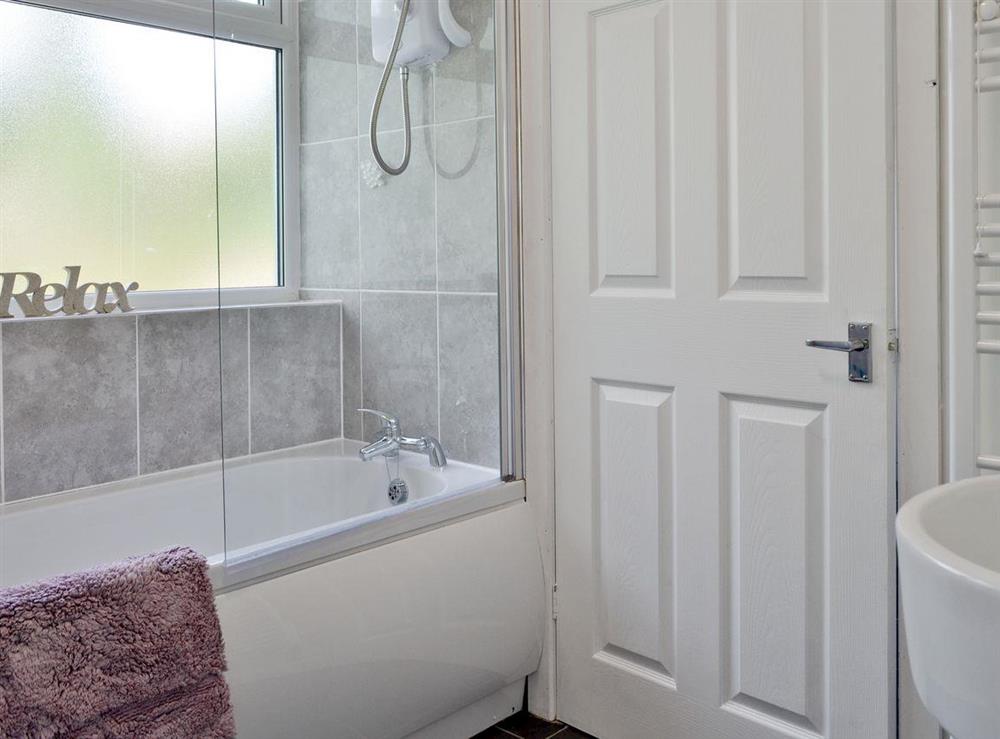 Family bathroom with shower above bath at Penteryfn in near Holyhead, Isle of Anglesey, Gwynedd