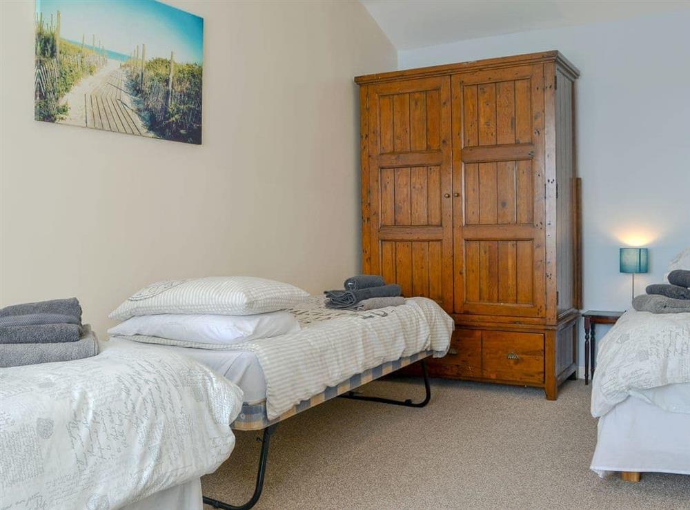 Large bedroom with three single beds at Penteryfn in near Holyhead, Isle of Anglesey, Gwynedd