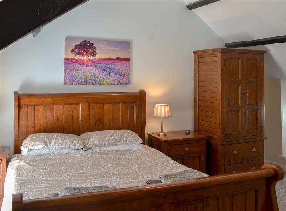 Luxurious sleigh bed in master bedroom at Penteryfn in near Holyhead, Isle of Anglesey, Gwynedd