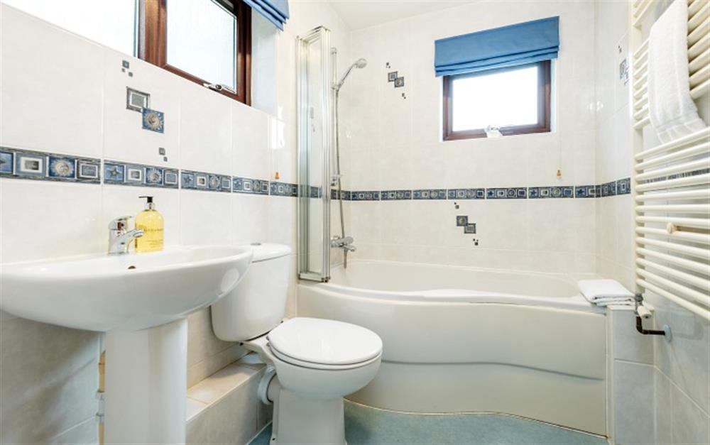 The family bathroom has a bath and overhead electric shower. at Penthouse in Maenporth