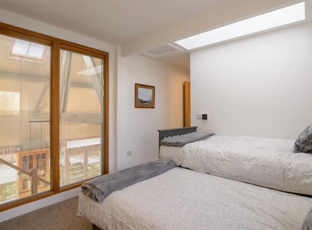 Twin bedded room overlooking the open plan living space at Penthwaite in Leyburn, North Yorkshire