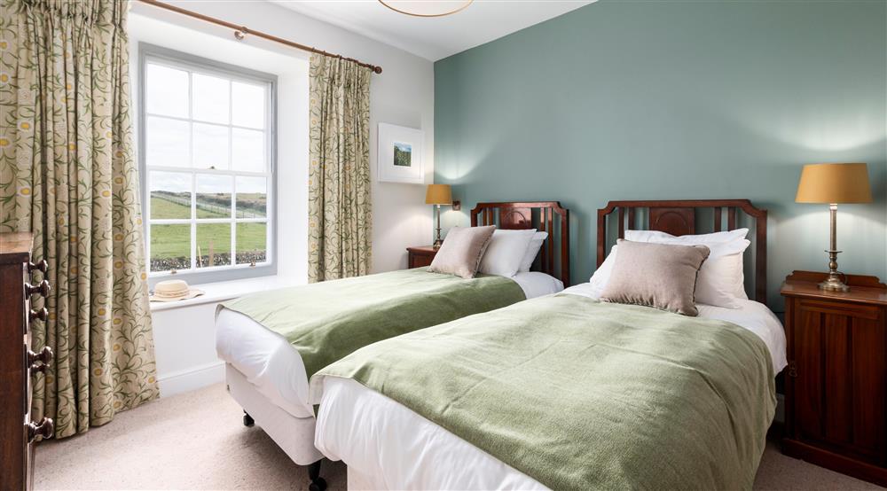 The first twin bedroom at Pentire Head Farmhouse in Polzeath, Cornwall
