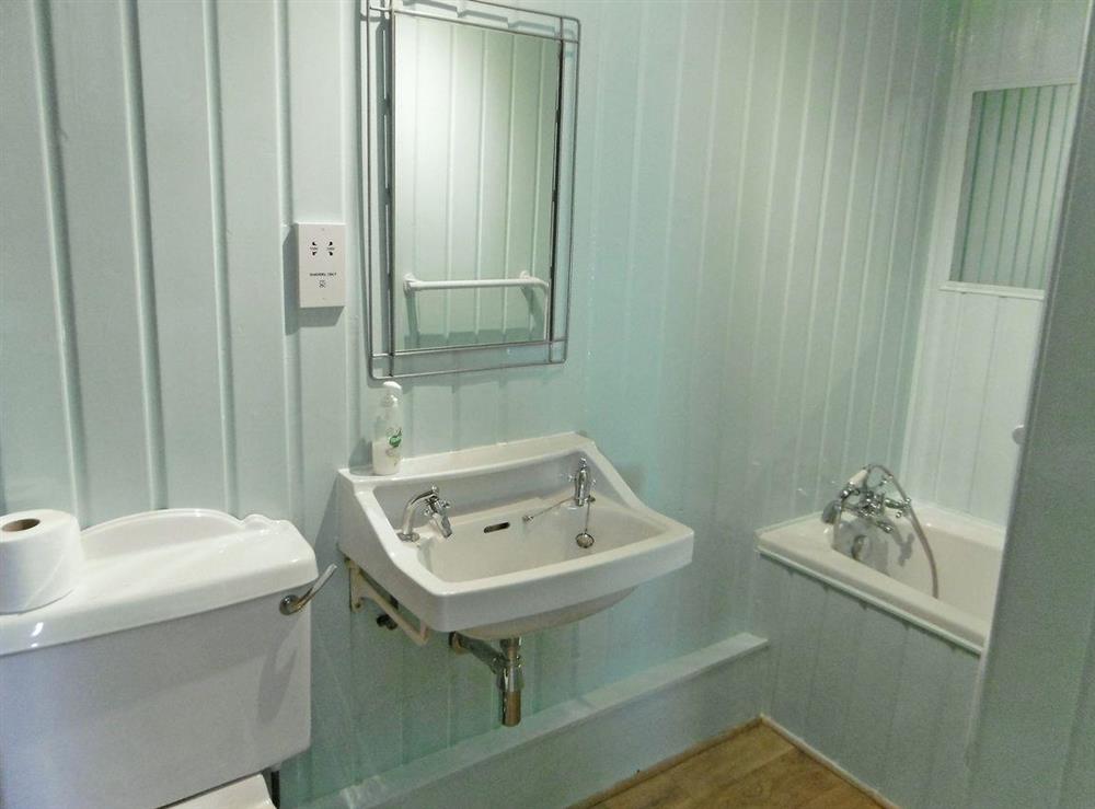 Delightful bathroom with shower over bath and toilet at Stable Cottage, 