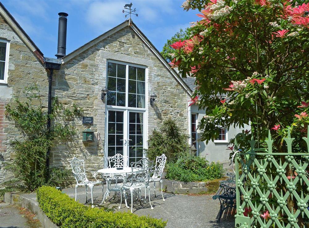 This light and airy cottage has French doors leading to a sunny courtyard at Stable Cottage, 