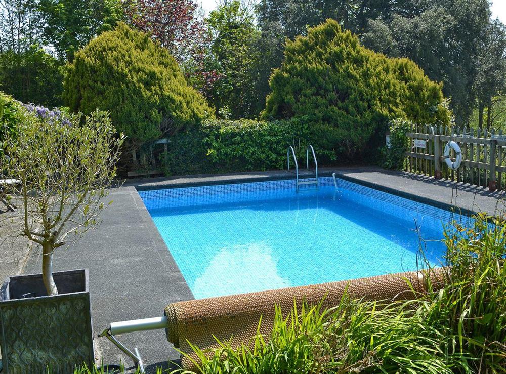 Heated swimming pool in grounds (shared with owner and other cottages on-site) at Stable End, 