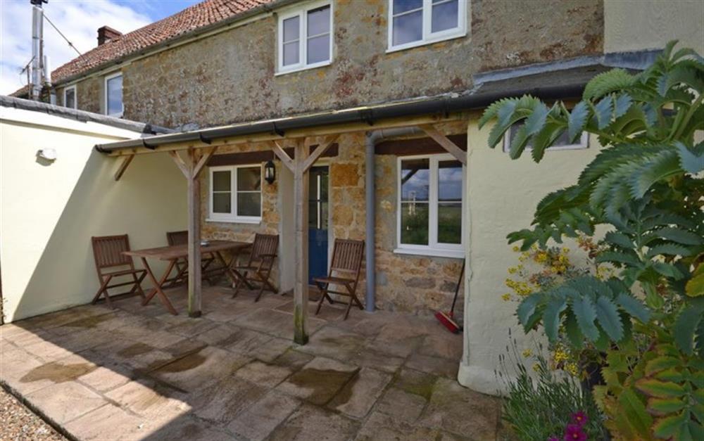 Patio area ideal for al-fresco dining at Perhay Cottage in Bridport