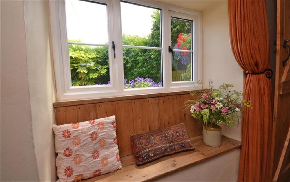 Pretty window seat overlooking the garden at Perhay Cottage in Bridport