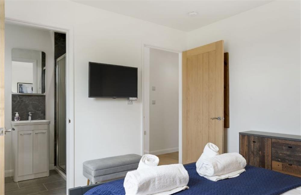 Perrywinkle, Praa Sands. Bedroom one with smart television and en-suite shower room.  at Perrywinkle, Ashton