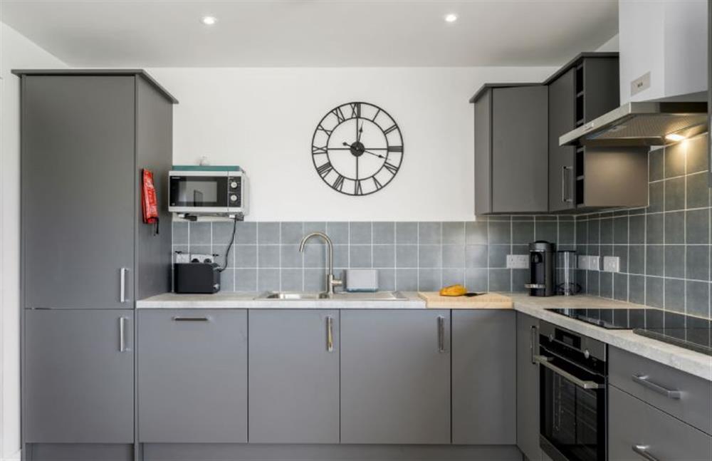 Perrywinkle, Praa Sands. Modern kitchen area with high gloss units, integrated electric oven and hob, fridge/freezer, dishwasher and washer/dryer.