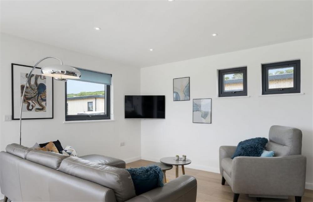 Perrywinkle, Praa Sands. Sitting room with comfortable corner sofa, easy armchair and smart television.