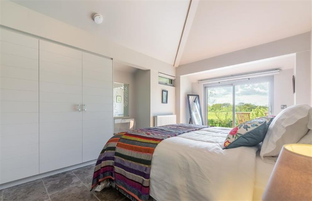 Ground floor: Built-in wardrobes in the master bedroom at Peterstone Lodge, Holkham near Wells-next-the-Sea
