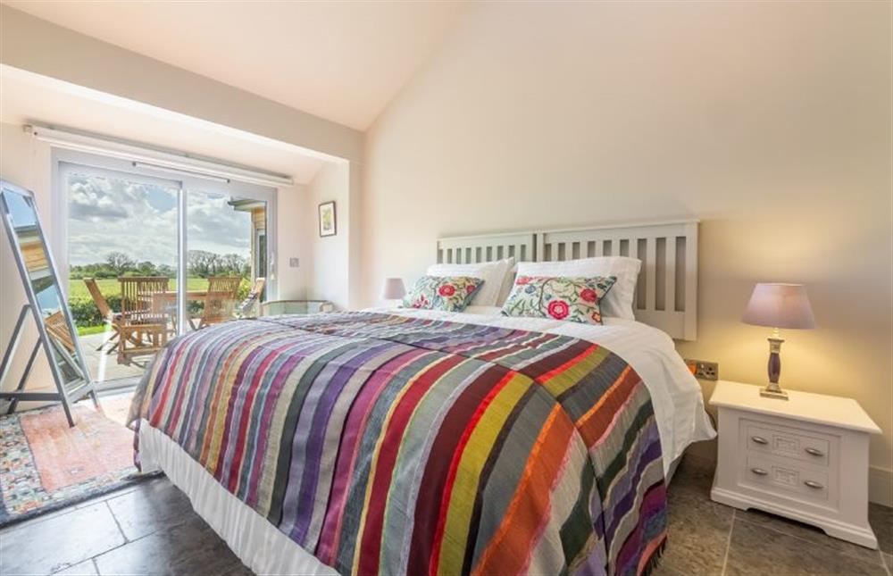Ground floor: The master bedroom has a super-king size zip-and-link bed at Peterstone Lodge, Holkham near Wells-next-the-Sea