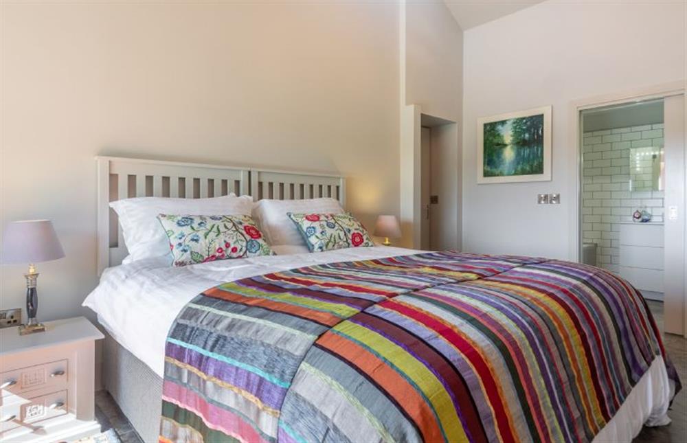 Ground floor: The master bedroom has an en-suite bathroom at Peterstone Lodge, Holkham near Wells-next-the-Sea