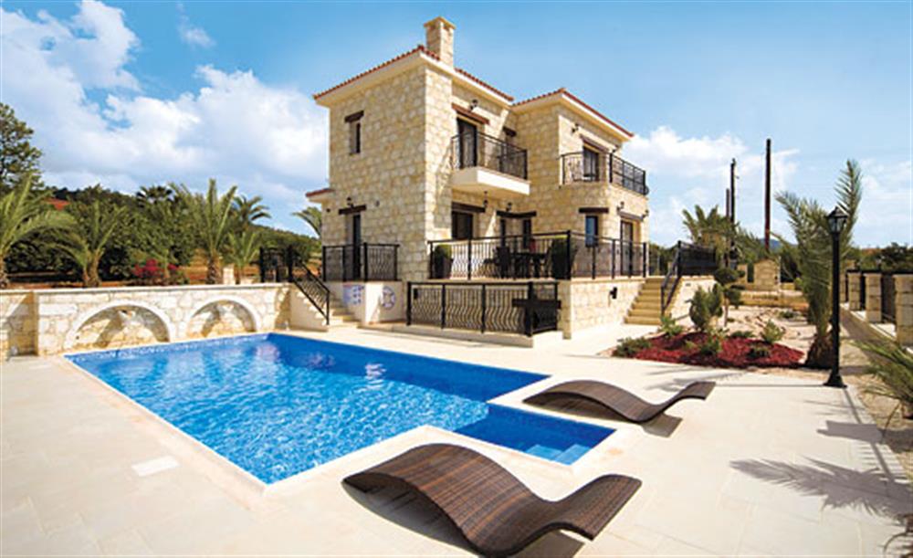 Swimming pool and sun loungers at Petrides Villa, Argaka, Cyprus