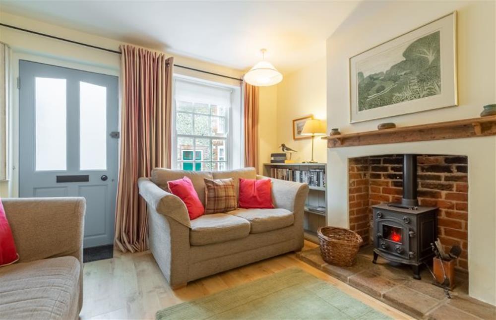 Ground floor: Cosy wood burning stove and comfy sofas at Petts Cottage, Burnham Market near Kings Lynn