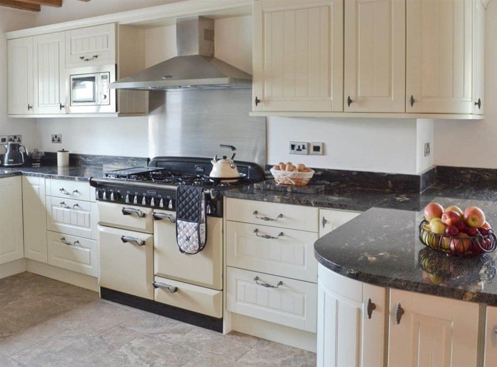 Beamed farmhouse-style kitchen at Pheasant Fields in Lloc, near Holywell, Clwyd