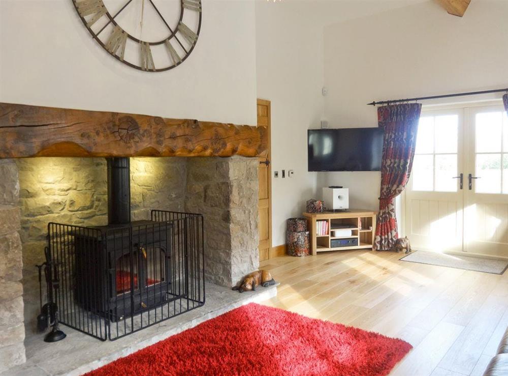 Large beamed living room with wood-burning stove (photo 3) at Pheasant Fields in Lloc, near Holywell, Clwyd
