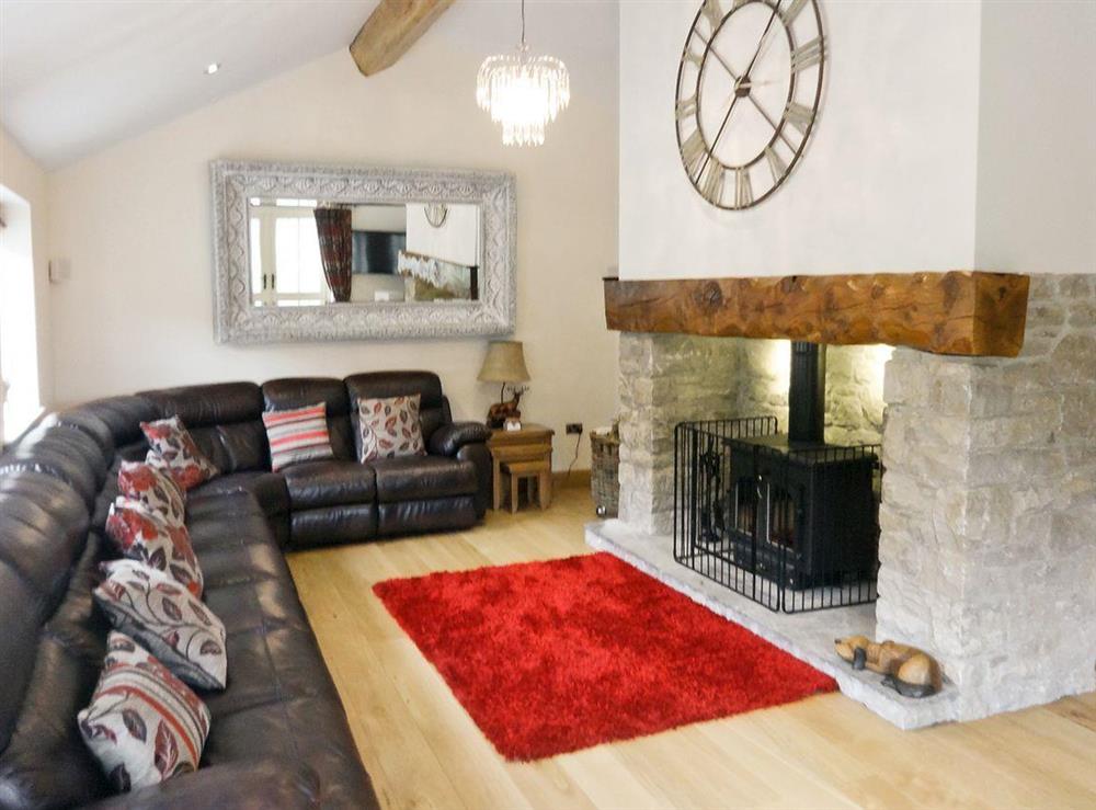 Large beamed living room with wood-burning stove at Pheasant Fields in Lloc, near Holywell, Clwyd