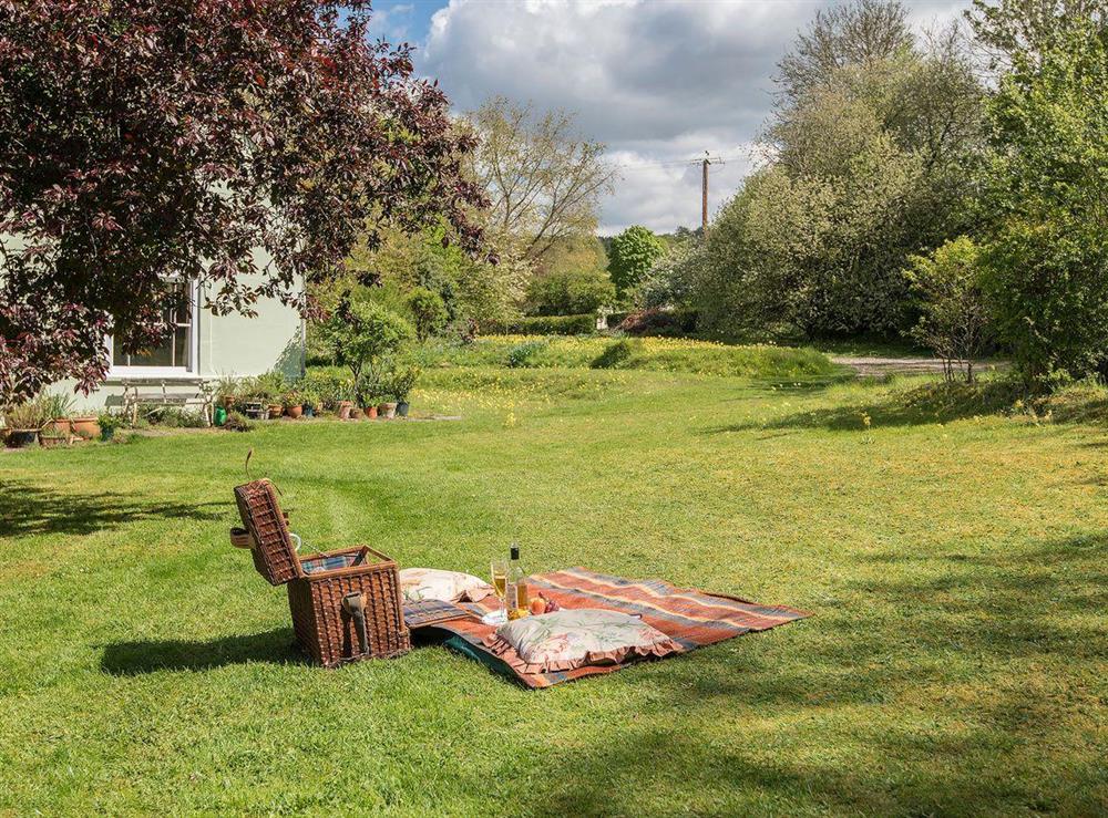 The large lawned garden makes an ideal spot for a picnic at Pheasants Hill Old Byre in Hambleden, near Henley-on-Thames, Buckinghamshire, England