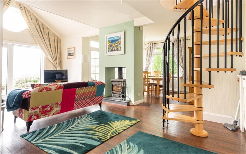 Lounge with staircase leading to triple bedroom at Phoenix and Little Phoenix in Talland Bay
