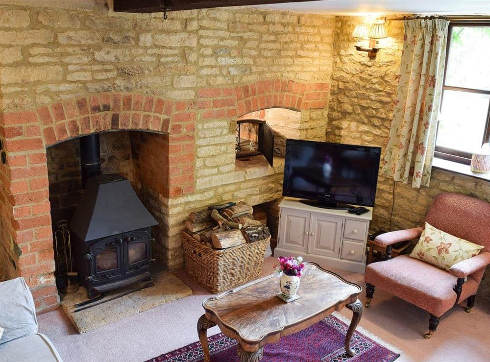 Cosy living room with wood burner at Picket Piece Cottage in Chadlington, near Chipping Norton, Oxfordshire