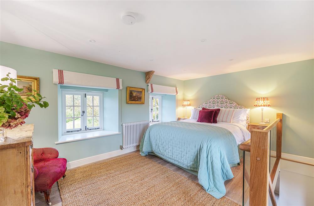 The king-size bedroom with views of the garden at Puddle Cottage at Piddle and Puddle, Dorchester