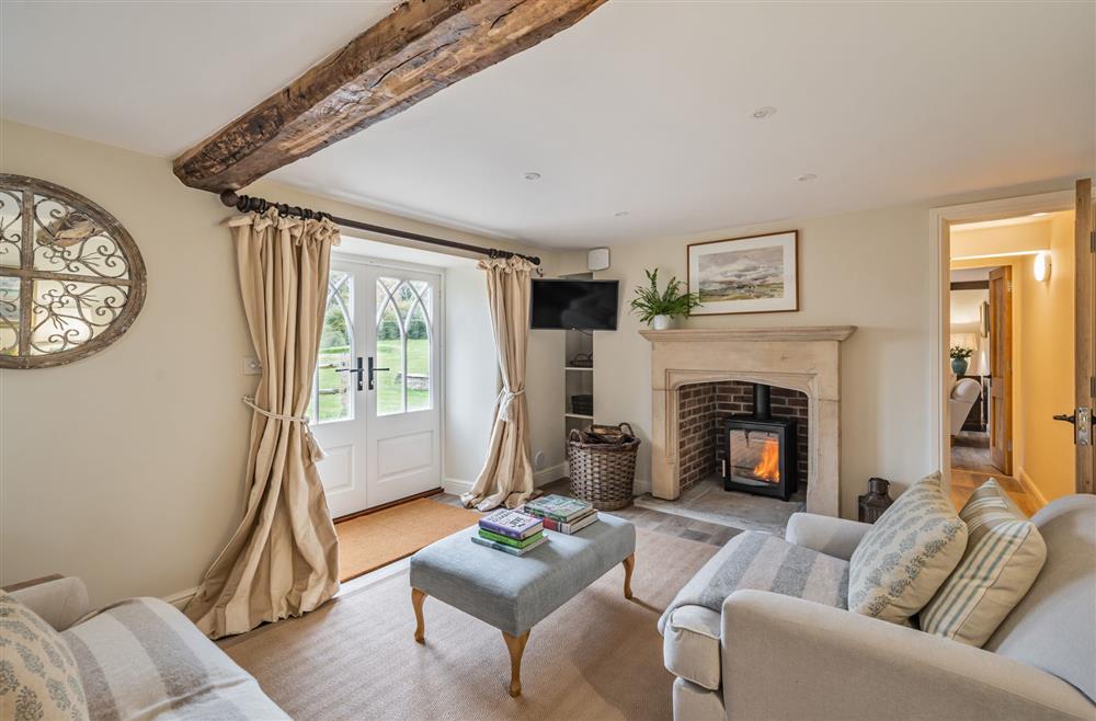 The attractive sitting room, with a wood burning stove at Piddle Cottage, Dorchester